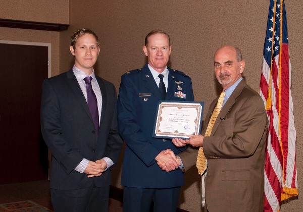 Casey Weinstein (l), chapter vice president for programs, joins Curtis in recognizing Col. Brian Parker, USAF, director, Enterprise Financial Systems Division, Electronic Systems Center, at the May luncheon.